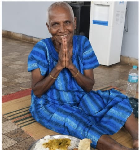 Gangammal smiling with folded hands in gratitude at the Blooming Heartz shelter home