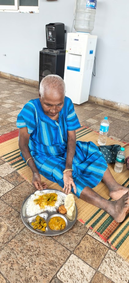 An elderly resident enjoying a warm, nutritious meal at Blooming Heartz